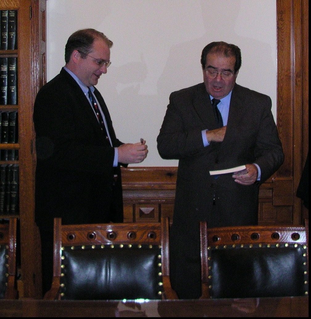 David Rogers with U.S. Supreme Court Justice Antonin Scalia, who is signing a book