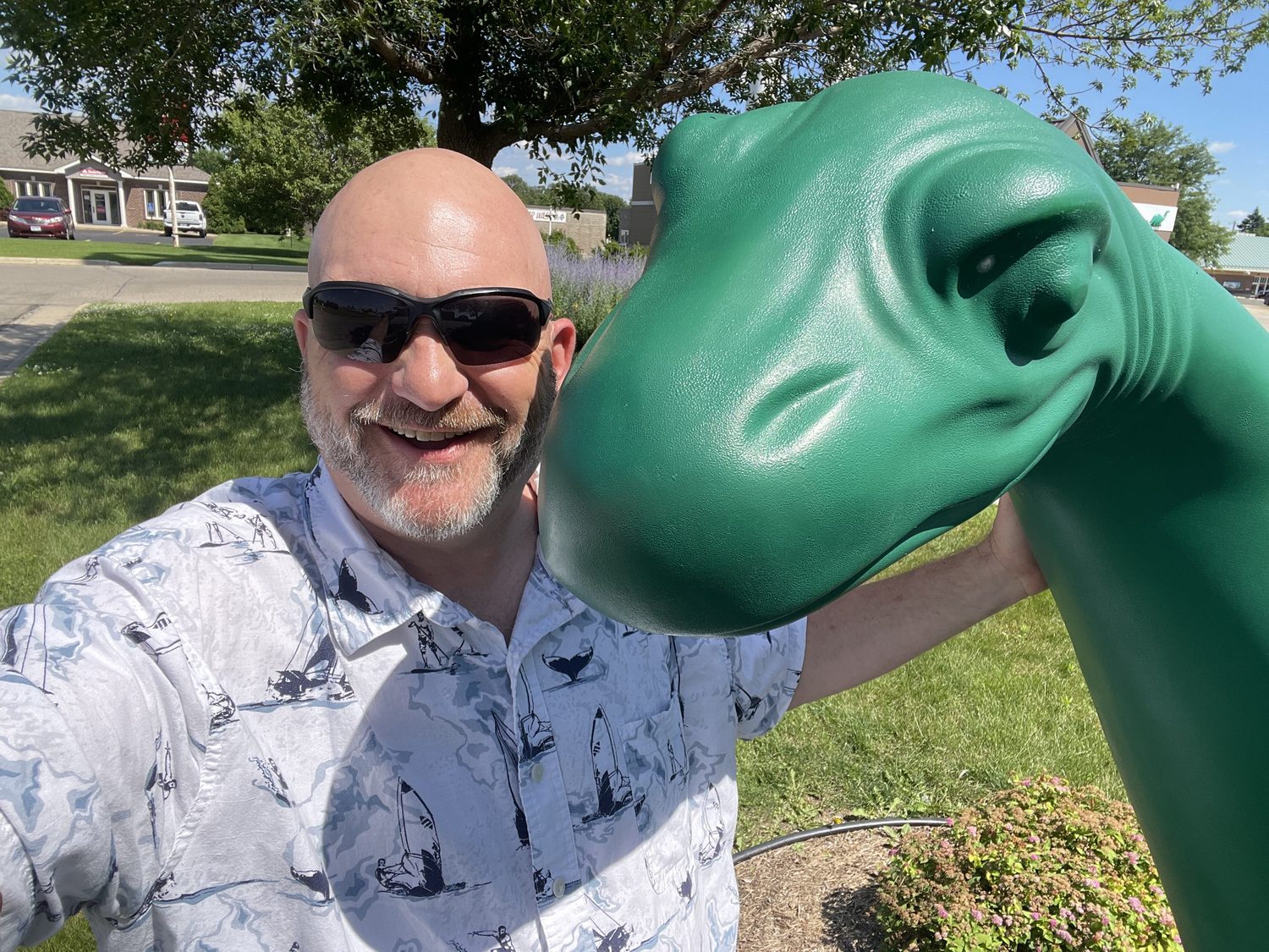 David Rogers having fun with a dinosaur