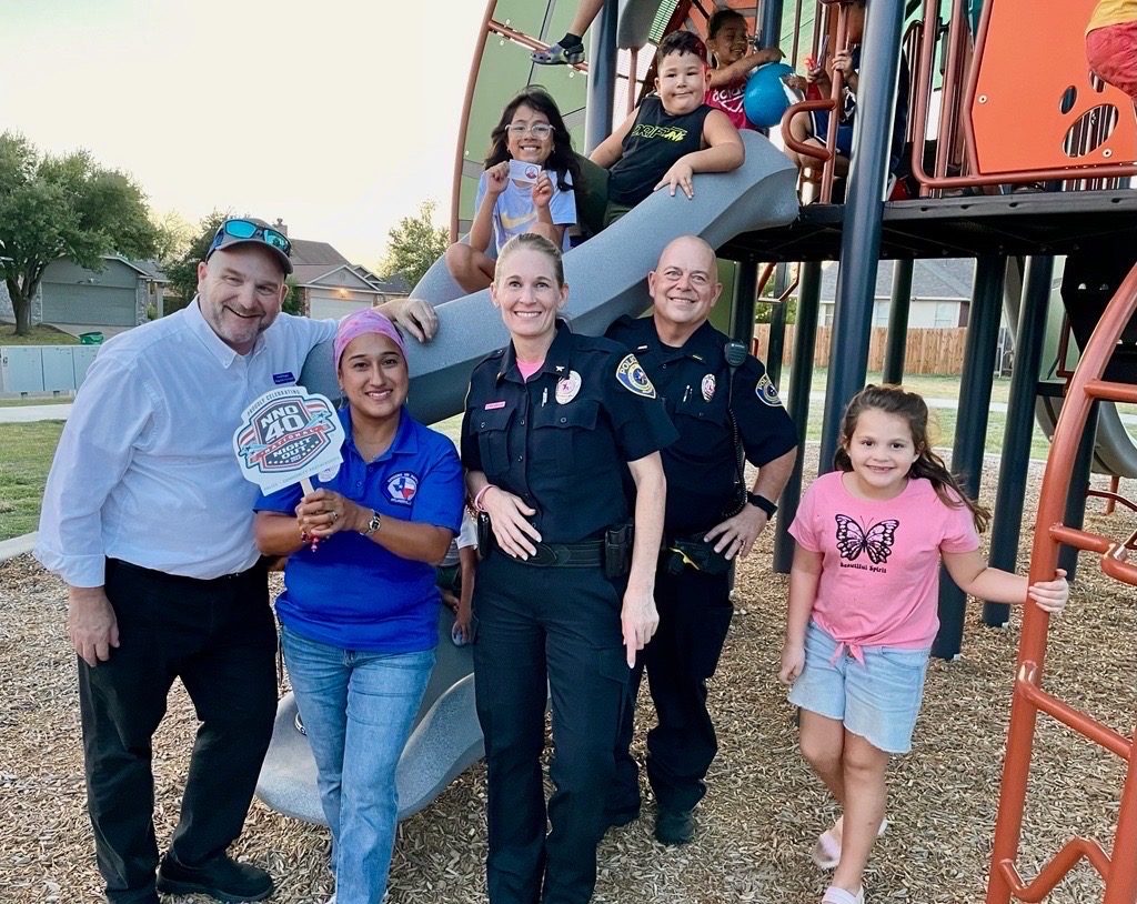 David Rogers with Pflugerville police officers and neighbors at National Night Out