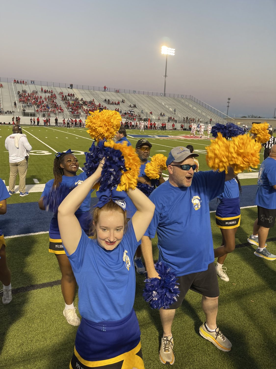 David Rogers with his daughter cheering for the Pflugerville Panthers